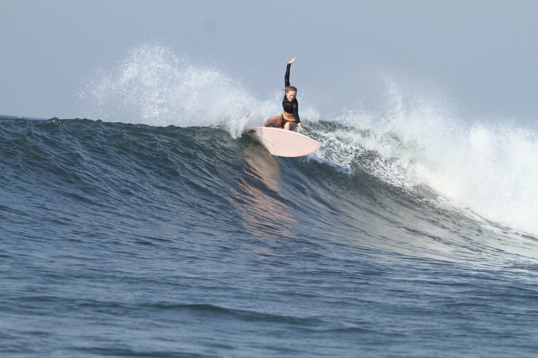 Surfer drawing a turn on a clean El Salvador wave