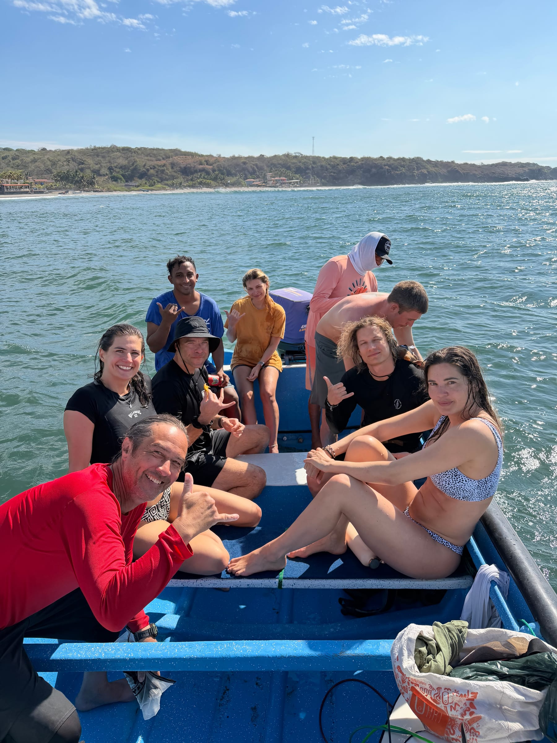 SurfXplore guests riding a boat along the El Salvador coast