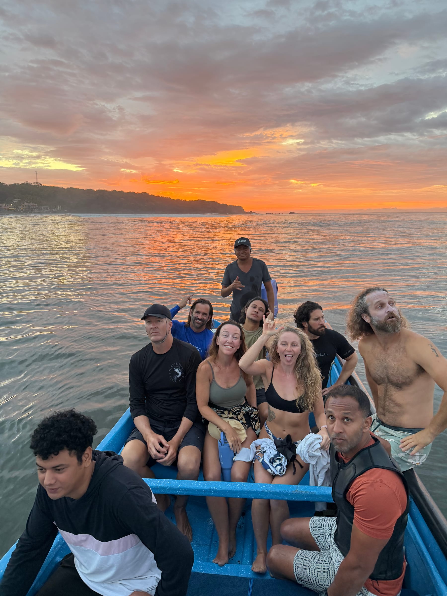 SurfXplore group on a boat at sunset in El Salvador