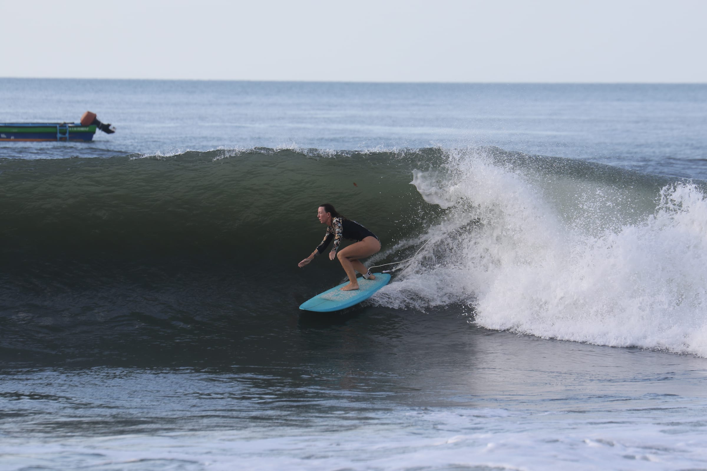 Surfer riding a clean right-hand wave in El Salvador