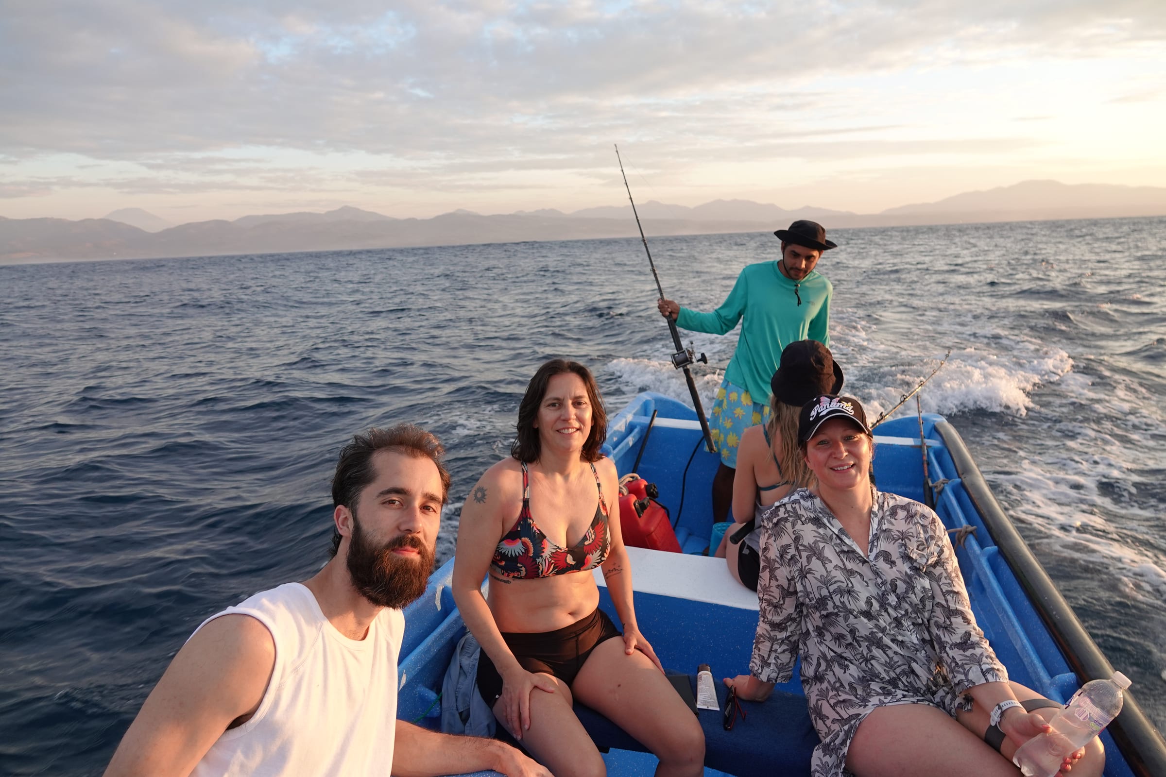 SurfXplore guests on a fishing boat at sunset in El Salvador