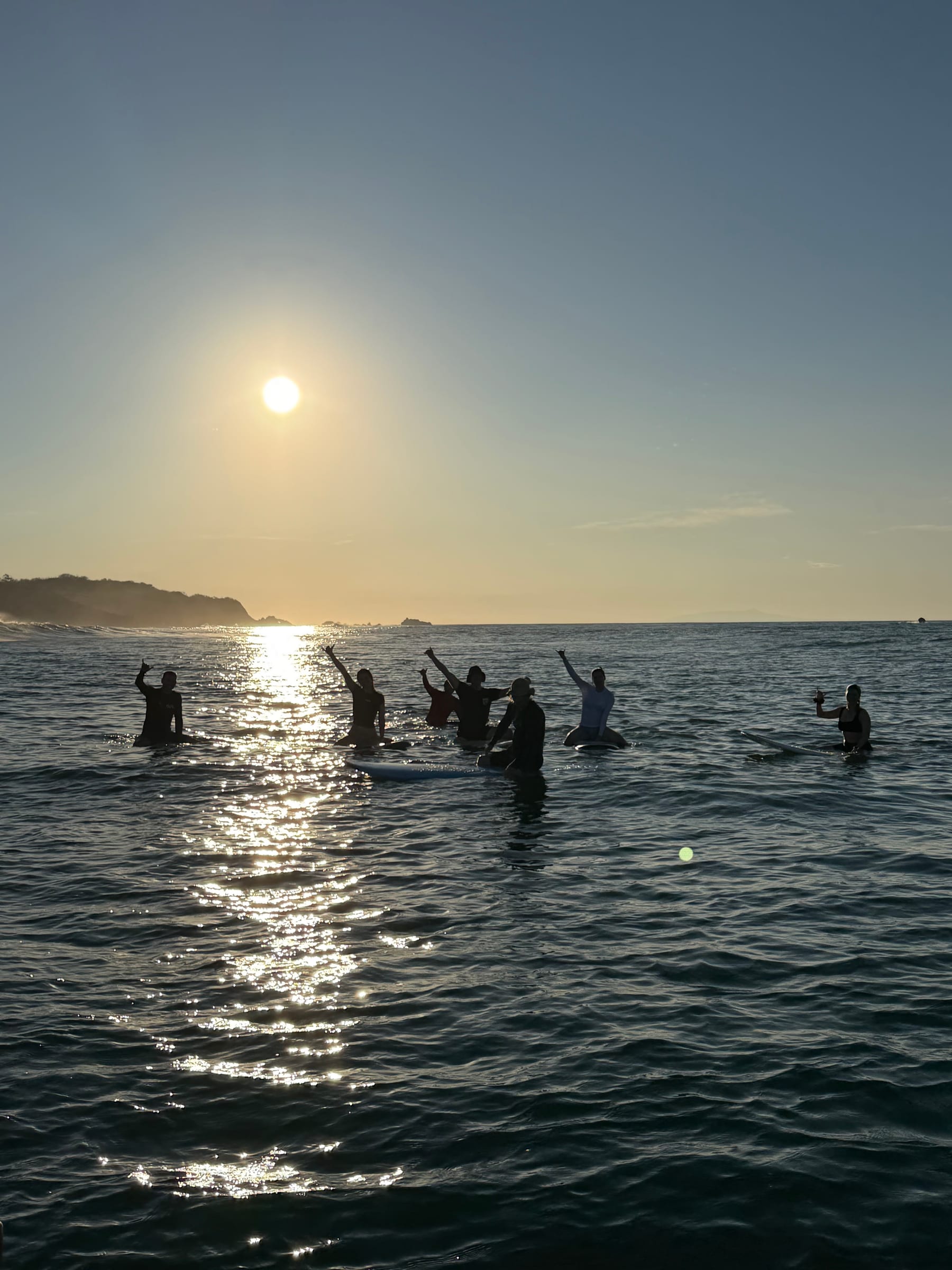 SurfXplore guests returning by boat after a sunset session in El Salvador