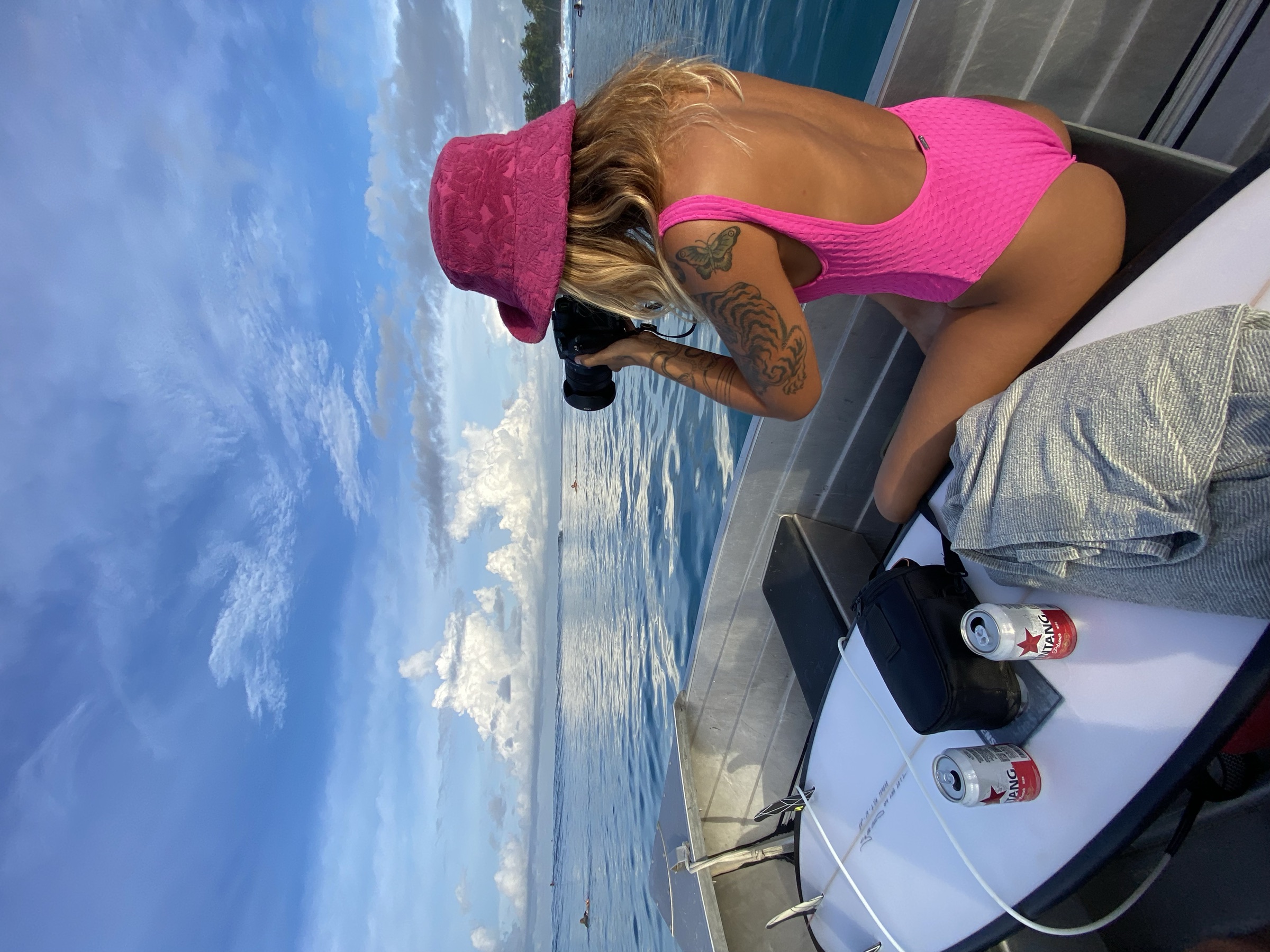 Surf photographer on a boat in the Mentawai Islands at sunset